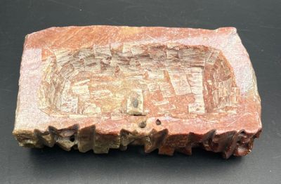 an image of a piece of rock with carvings on it