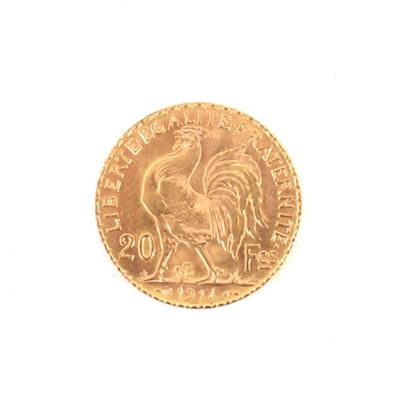 une pièce d'or représentant un coq sur un fond blanc