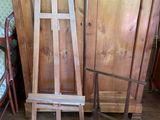 two wooden chairs and a wooden easer in a room