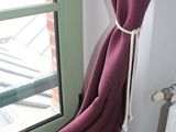 a window with a curtain on it and a radiator in front of it
