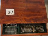 a wooden box with silverware in it on a table