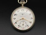 une montre de poche antique sur une surface noire avec un fond noir