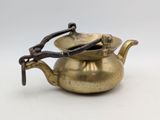 an old brass teapot with a handle and a handle on it