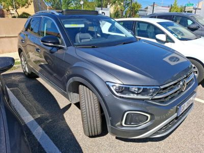 the volkswagen suv is parked in a parking lot next to other cars