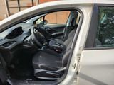 the interior of a car with the door open and the driver ' s seat down