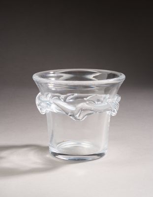 a small glass vase with a leaf design on it