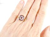 an image of a woman ' s hand with a diamond and ruby ring