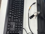 a computer keyboard and a mouse on a desk