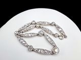 an image of a diamond necklace on a mannequin display