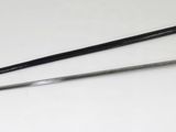 two swords that are laying on a white surface
