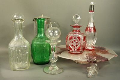 a lot of glass bottles and glasses on the table