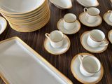 a lot of plates and cups on the table