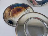 three plates on a table with a mirror in the background
