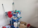 a blue cart with cleaning supplies in it in a room