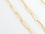 a close up of a gold chain on a white surface