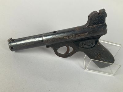 a close up of a gun on display on a white surface