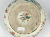 a bowl with a bird on it sitting on a table