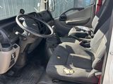 a white van with a black seat and steering wheel
