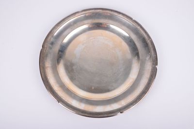a silver plate on a white surface with a white background