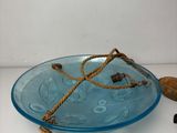 a blue glass plate with a rope on top of it