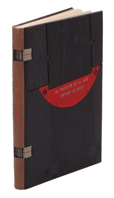 un vieux livre à la couverture noire et aux bordures rouges