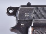 a close up of a gun on a white surface