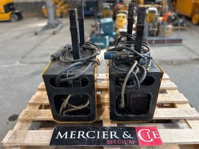 two speakers sitting on a pallet in a warehouse