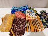 several different types of scarves laid out on a table