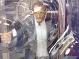 a toy figure of a man in a suit and glasses