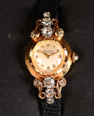 a close up of a watch on a black cloth