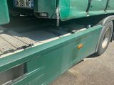 a green truck that is parked on the side of the road