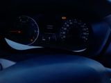 steering wheel of a car with a view of a parking lot in the background