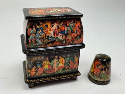 a small box with a lid that has a painting on it