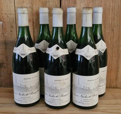 six bottles of wine are lined up on a wooden shelf