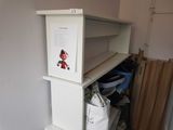 a white shelf with a sign on it in a room