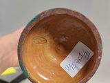 a person holding a cup with a sticker on it