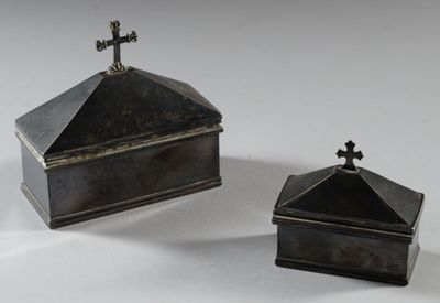 pair of silverplated boxes with crosses on top of them