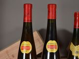 three bottles of wine sitting on a table next to each other