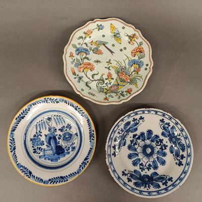 three blue and white plates with floral designs on them on a table