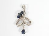a close up of a blue and white diamond pendant on a white background