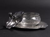 a glass cup and saucer sitting on a saucer