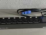 a black power strip with a blue and black plugged in it
