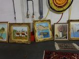 many paintings on the floor in a room