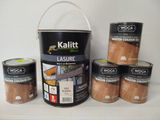 five cans of paint sitting on a shelf next to a bucket of wood