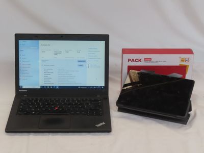 a laptop computer sitting next to a box of packages