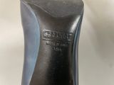 the bottom of a pair of black shoes on a white surface