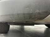 a close up of a car ' s rear end with a flat tire