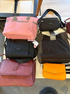 a lot of purses that are sitting on a table