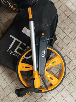 a black bag with a yellow wheel and a black bag with a black handle