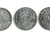 three different types of silver coins on a white surface